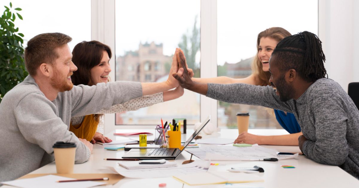People in a meeting, participating in a group cheer
